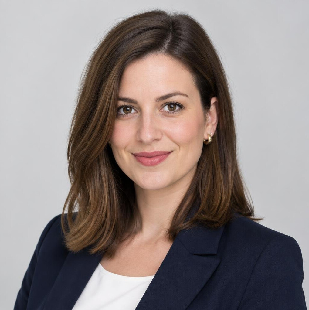 Studio portrait of a woman with shoulder length hair smiling